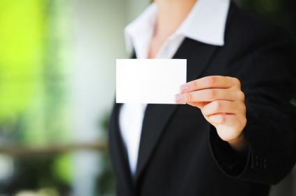 A business woman holding a business card